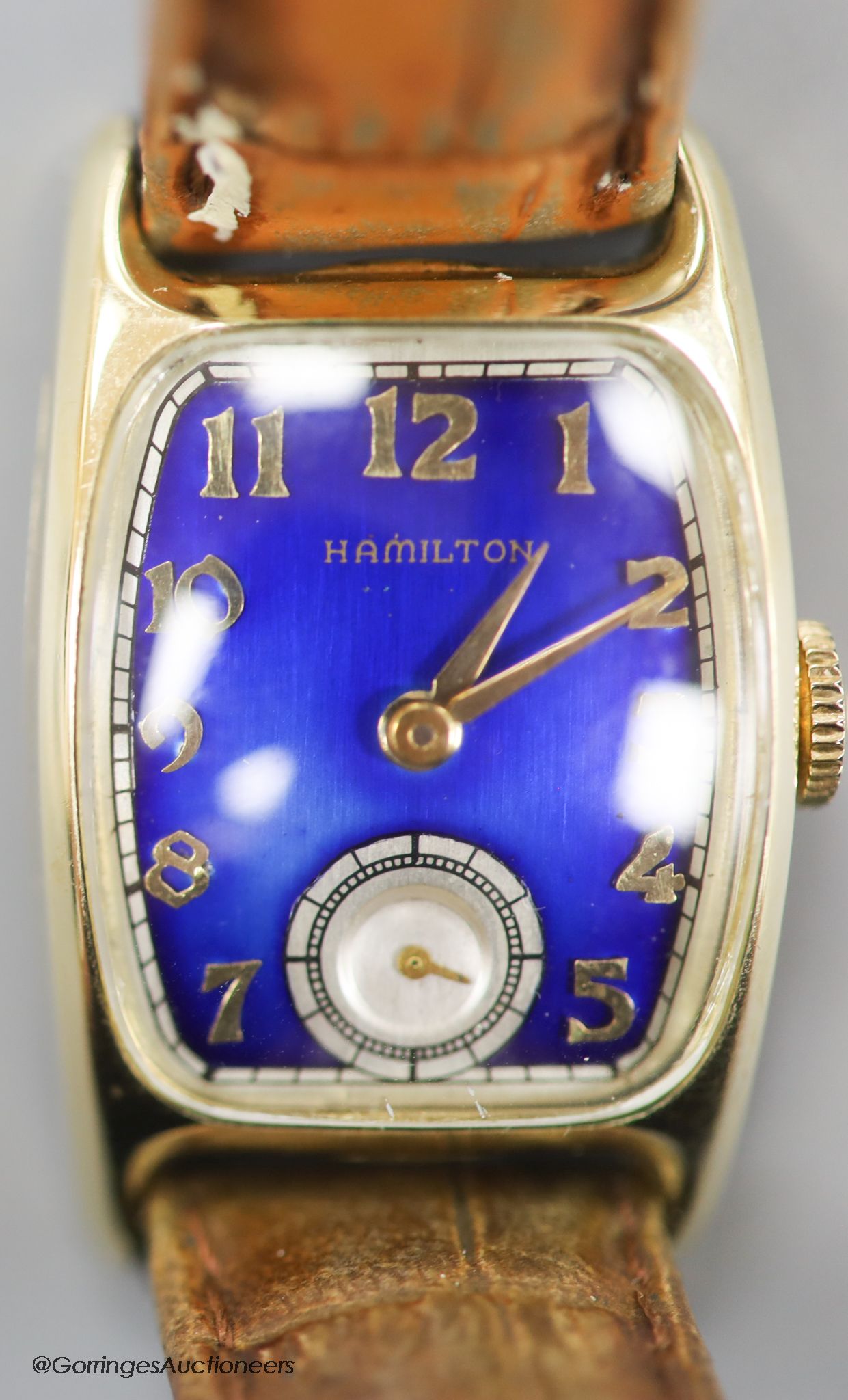A gentleman's 1930's 14k gold filled Bulova manual wind wrist watch with blue enamel rectangular dial and subsidiary seconds, on a leather strap.